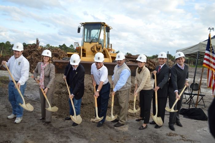 Council members and others involved in the project shoveling dirt